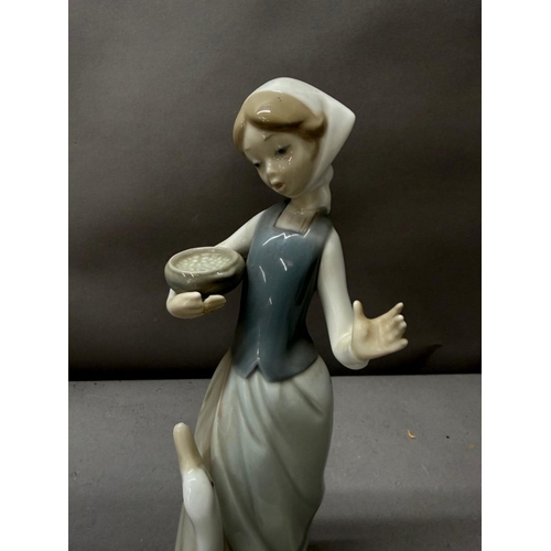 256 - Two Lladro porcelain figures one of a girl with a lamb the other of a girl with a goose. Tallest app... 