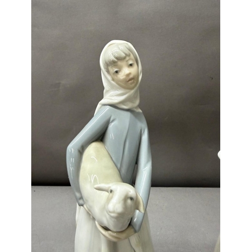 256 - Two Lladro porcelain figures one of a girl with a lamb the other of a girl with a goose. Tallest app... 