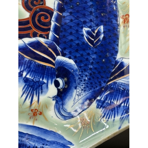 271 - A vintage octagonal Japanese charger with Koi Carp decoartion, signed to base for the Fukagawa Siji ... 