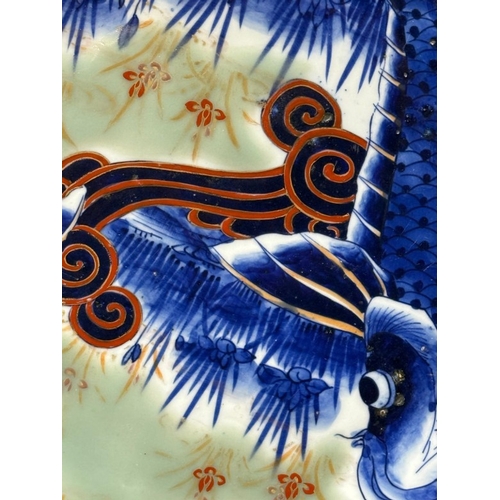 271 - A vintage octagonal Japanese charger with Koi Carp decoartion, signed to base for the Fukagawa Siji ... 