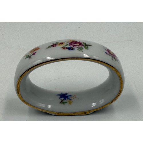 284 - A set of six French florally painted ceramic napkin rings