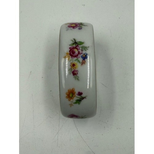 284 - A set of six French florally painted ceramic napkin rings