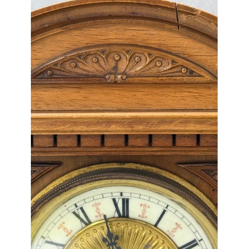 383 - An oak cased German 14-day mantel clock with brass and enamel face, Roman numeral and carved pedimen... 