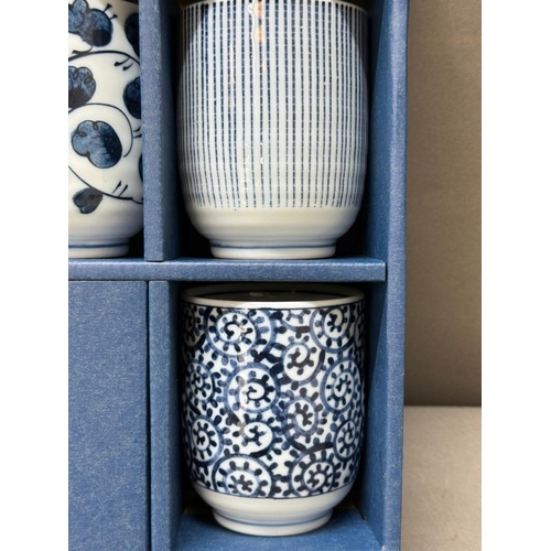 123 - A boxed set of blue and white tea cups