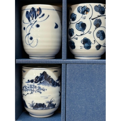 123 - A boxed set of blue and white tea cups