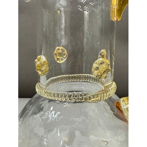 150 - A yellow amber and clear glass pitcher and four matching glasses with an etched vine leaf motif