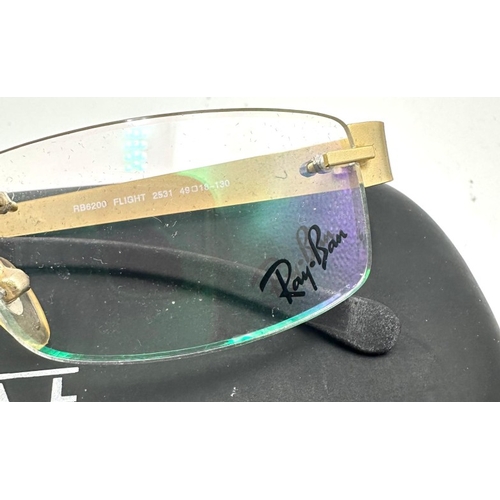 16 - A pair of Ray Ban rimless glasses and a pair of Tom Archer sunglasses