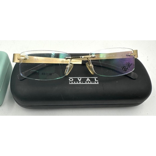 16 - A pair of Ray Ban rimless glasses and a pair of Tom Archer sunglasses