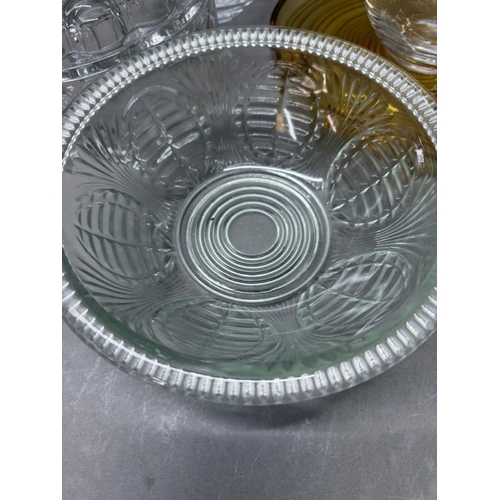 172 - A selection of glassware to include two Distington crystal decanters, a jelly mould and yellow foote... 