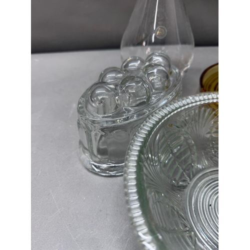 172 - A selection of glassware to include two Distington crystal decanters, a jelly mould and yellow foote... 