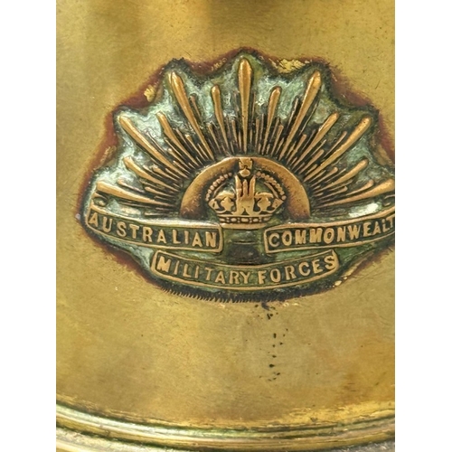 175 - A trench Art brass shell case converted into a lidded pot and embossed with the crest of the Austral... 