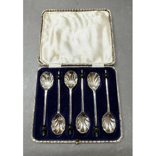 178 - A boxed set of six silverplate scallop coffee spoons