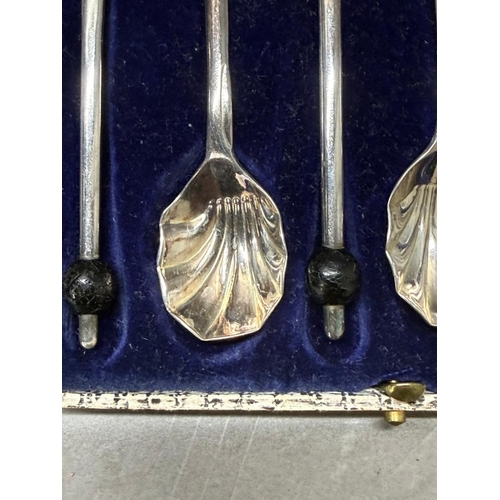 178 - A boxed set of six silverplate scallop coffee spoons