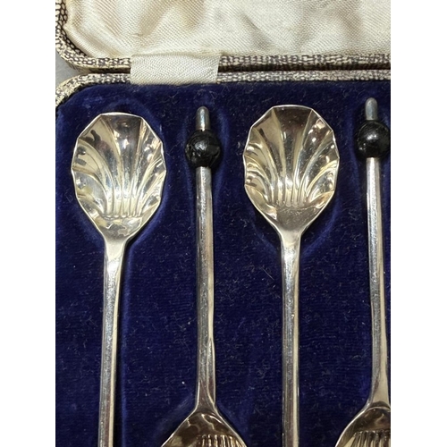 178 - A boxed set of six silverplate scallop coffee spoons