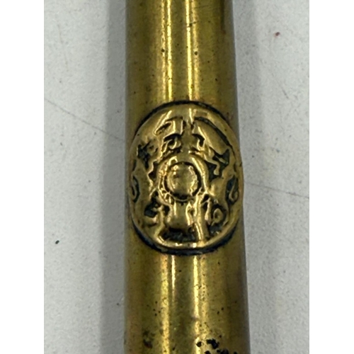 37 - A Trench Art letter opener along with an Army Ordnance Cap Badge.