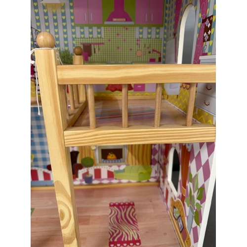 39 - A Dolls House with pink roof and multiple colourful rooms.
