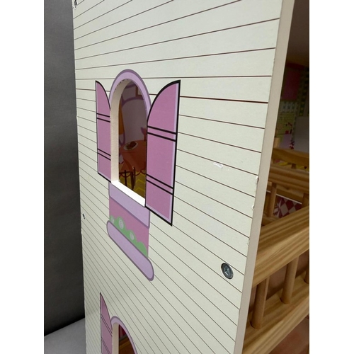 39 - A Dolls House with pink roof and multiple colourful rooms.