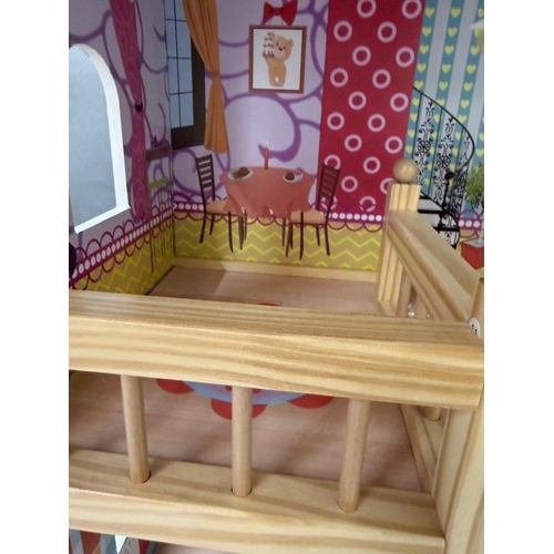 39 - A Dolls House with pink roof and multiple colourful rooms.