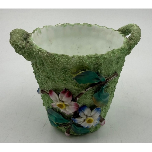 49 - A small decorative plant pot with floral relief