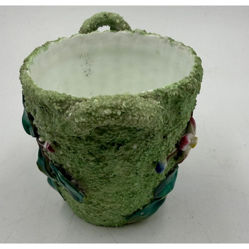 49 - A small decorative plant pot with floral relief