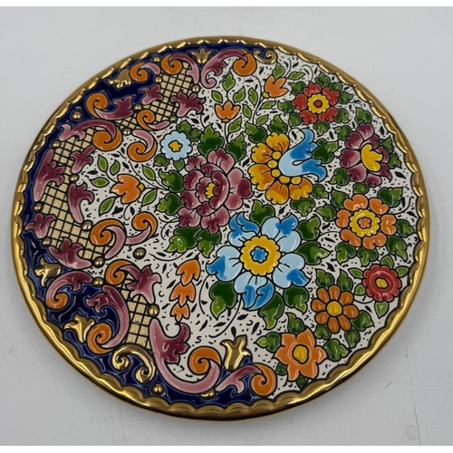 51 - A decorative Spanish wall hanging plate with floral design