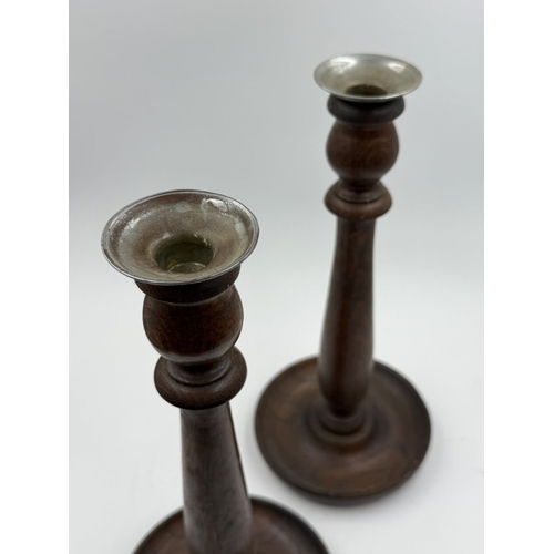 101 - A pair of wooden candlesticks