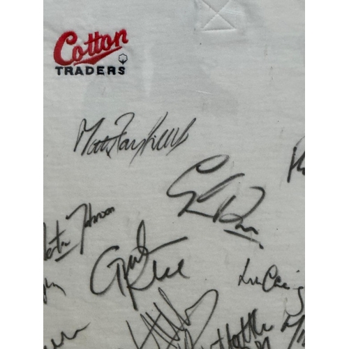 104 - A framed England rugby shirt signed by members of the England rugby team including Martin Johnson an... 