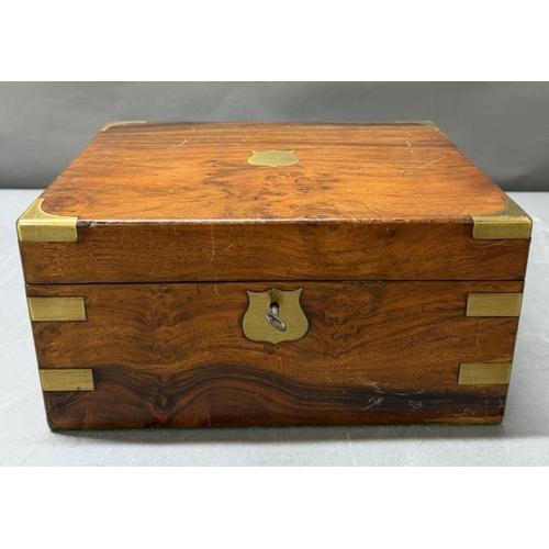 111 - A Mahogany brass banded writing box with integral red leather writing slope and hidden drawer.