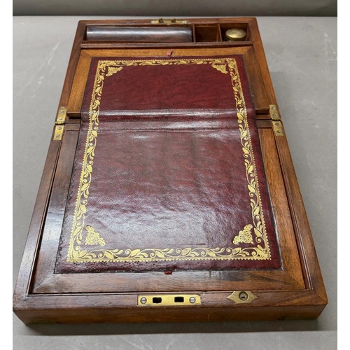 111 - A Mahogany brass banded writing box with integral red leather writing slope and hidden drawer.