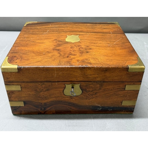 111 - A Mahogany brass banded writing box with integral red leather writing slope and hidden drawer.