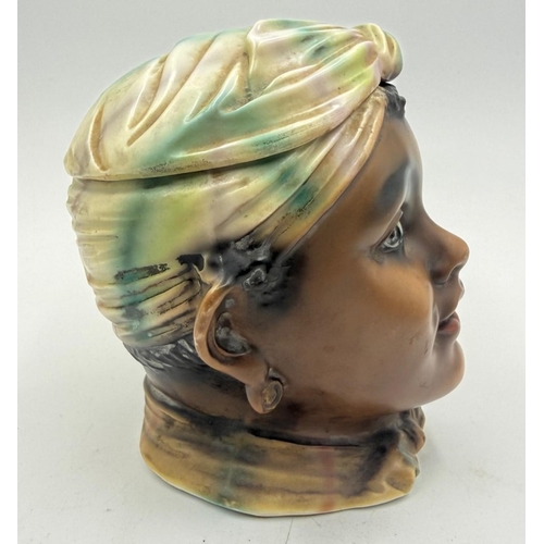 124 - A bisque early 20th century tobacco jar depicting an Afro American lady.
