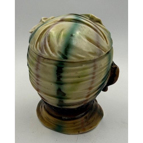 124 - A bisque early 20th century tobacco jar depicting an Afro American lady.