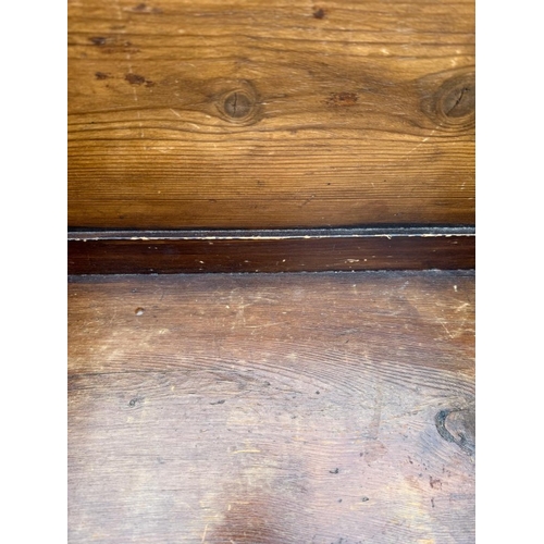 134 - An oak four seater church pew with gothic carved panels and scrolling arms H90cm W260cm D39cm