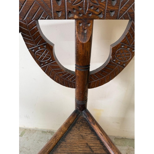 138 - A carved Swedish tripod monks chair