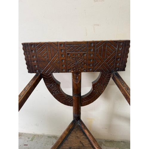 138 - A carved Swedish tripod monks chair