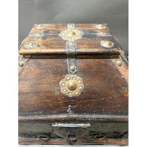 140 - An Indian hardwood drawer chest with a hammered brass finish and two short drawers under