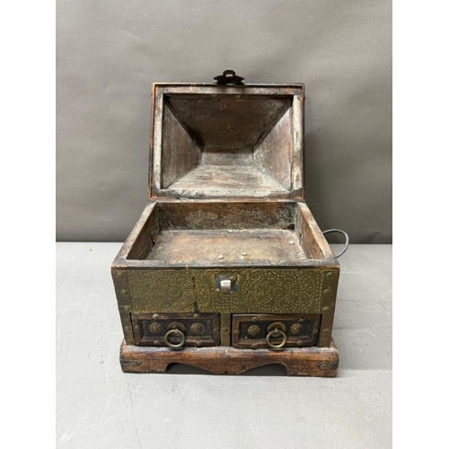 140 - An Indian hardwood drawer chest with a hammered brass finish and two short drawers under