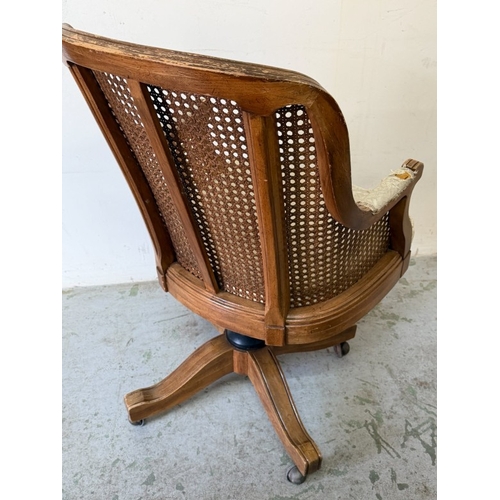 141 - Maple and Co desk chair with cane back swivel action