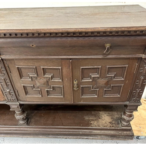 151 - A Jacobean style oak sideboard featuring two drawers over two cupboards H95cm W197cm D65cm