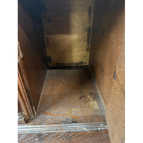 154 - An oak four drawer bureau with brass handles, the fall opening to pigeon holes and drawers H107cm W9... 