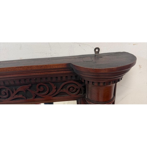 162 - A mahogany overmantel mirror with carved top and fluted columns to sides 122cm x 95cm