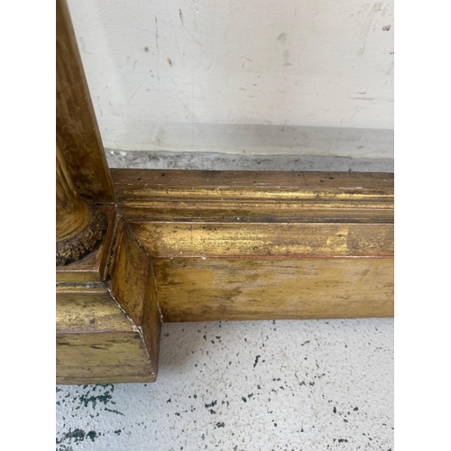 169 - A Regency style giltwood mirror frame with a Neoclassical frieze to the top and flanked by Empire st... 