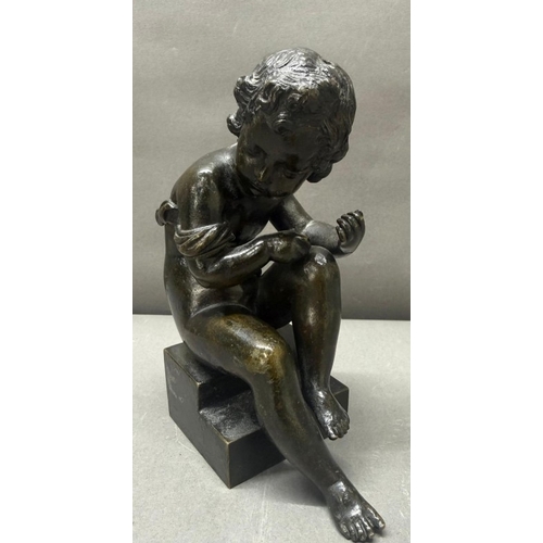 75 - A French school bronze figure of a seated cherub H17cm
