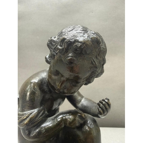 75 - A French school bronze figure of a seated cherub H17cm