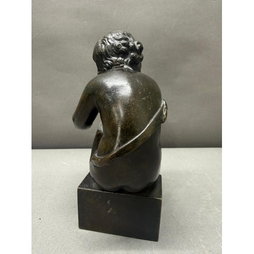 75 - A French school bronze figure of a seated cherub H17cm