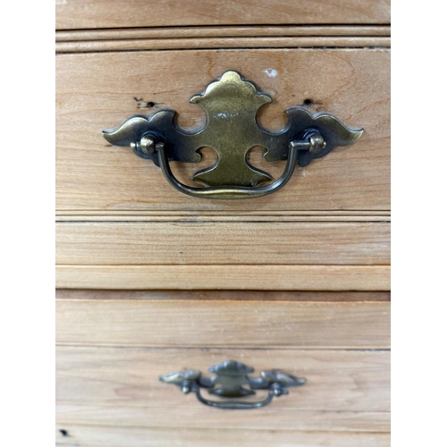 78 - A pine three drawer chest with a hinged mirror to top flanked by trinket drawers H153cm W92cm D50cm