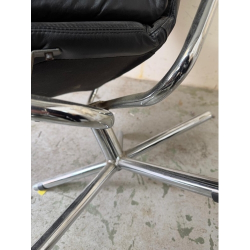 79 - Black leather lounge chair with matching footstool and chrome swivel base by Skoghaug Industries