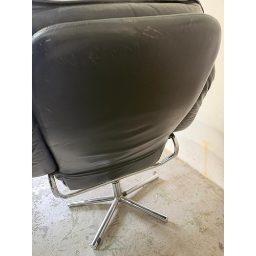 79 - Black leather lounge chair with matching footstool and chrome swivel base by Skoghaug Industries