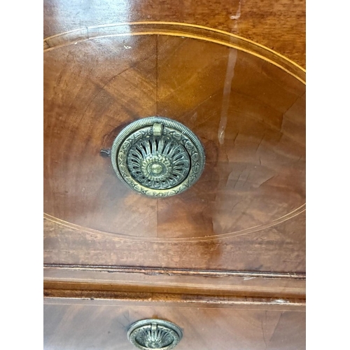 83 - A mahogany four-drawer chest of drawers with brass hoop handles H108cm W104cm D52cm