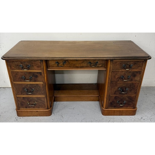 84 - A mahogany knee hole desk with a central drawer and flanked by faux drawers and cupboards